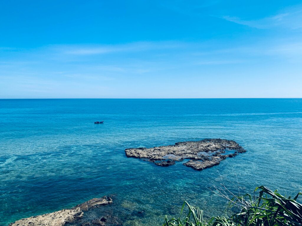 a body of water with rocks in the middle of it